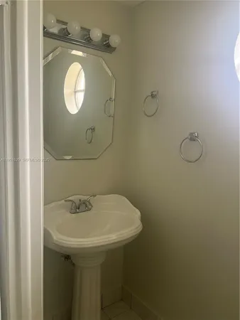 a white toilet sitting next to a window