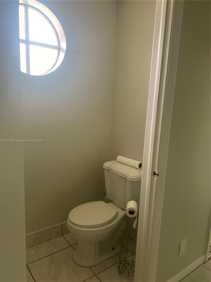 River Run Miramar, FL 33025 - Photo 26 of 29 a white toilet sitting next to a window