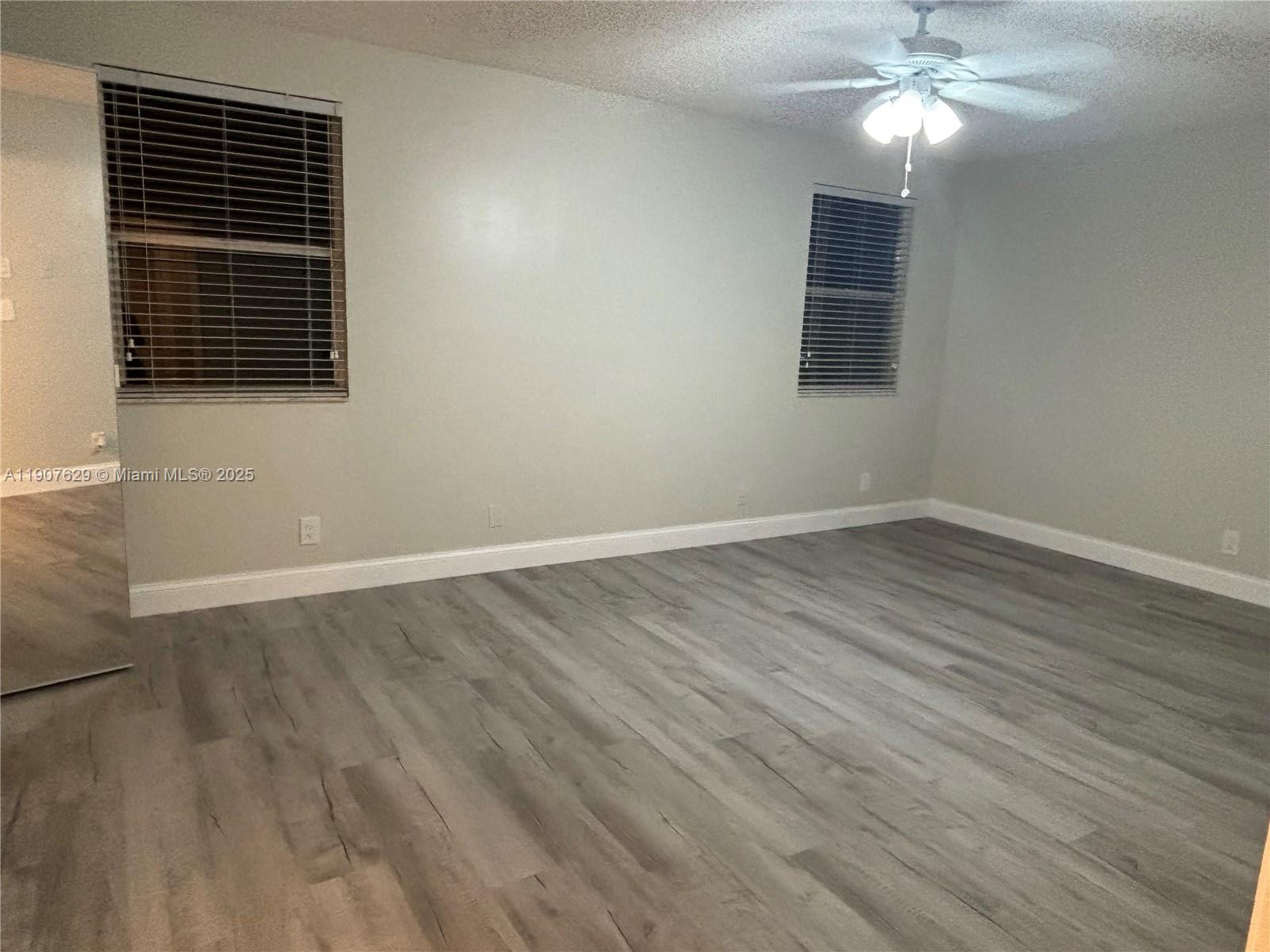 River Run Miramar, FL 33025 - Photo 8 of 29 a view of a livingroom with wooden floor and a ceiling fan