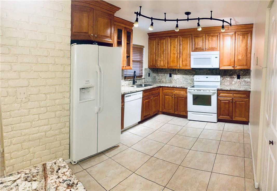 9601 Riverside Drive, Unit A10 Coral Springs, FL 33071 - Photo 1 of 15 a kitchen with stainless steel appliances granite countertop a stove a sink and a refrigerator