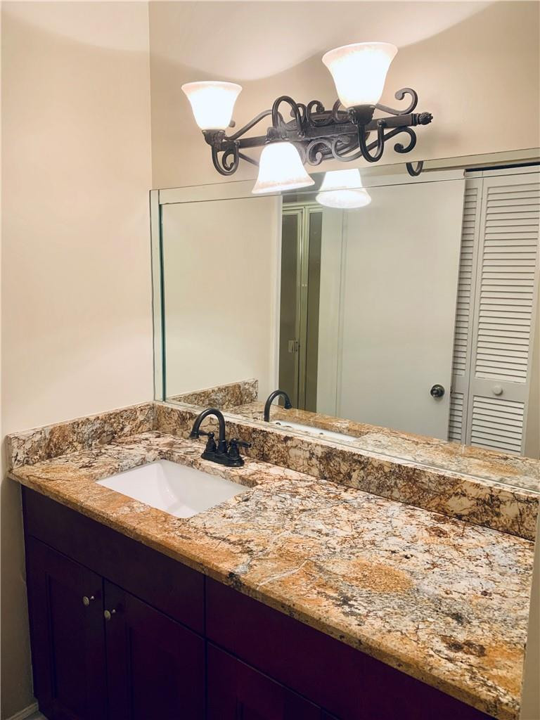 9601 Riverside Drive, Unit A10 Coral Springs, FL 33071 - Photo 5 of 15 a bathroom with a sink and a mirror