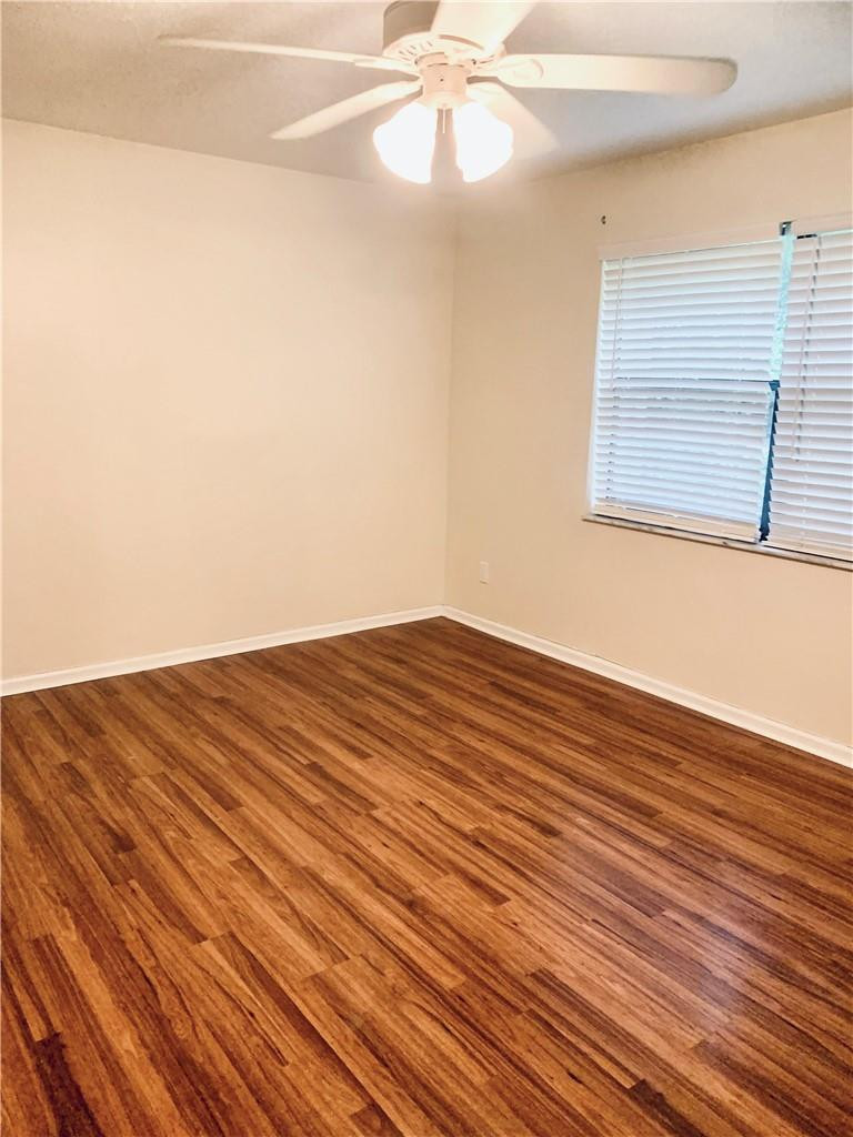 9601 Riverside Drive, Unit A10 Coral Springs, FL 33071 - Photo 7 of 15 a view of a room with wooden floor and a ceiling fan