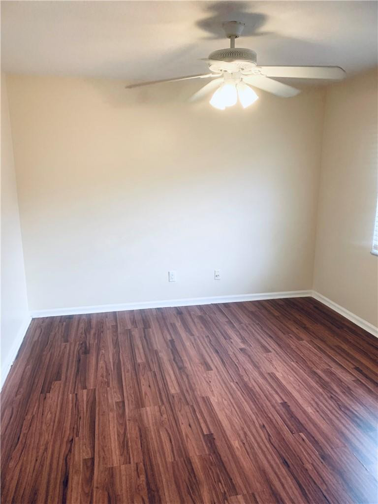 9601 Riverside Drive, Unit A10 Coral Springs, FL 33071 - Photo 9 of 15 a view of a room with wooden floor and a ceiling fan