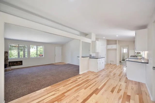 a kitchen with granite countertop white cabinets and white appliances