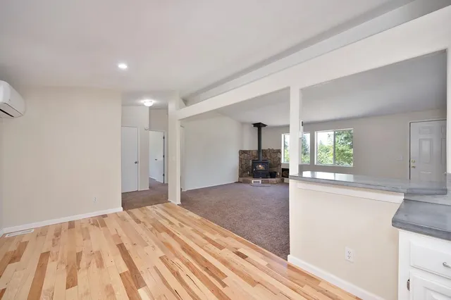 a view of a big room with a ceiling fan and a window