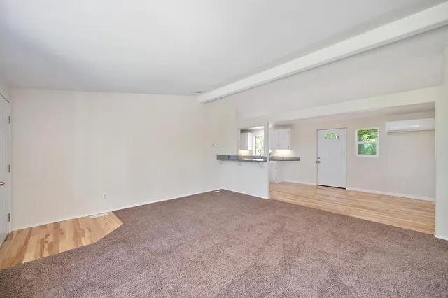 a bathroom with a granite countertop toilet sink and mirror