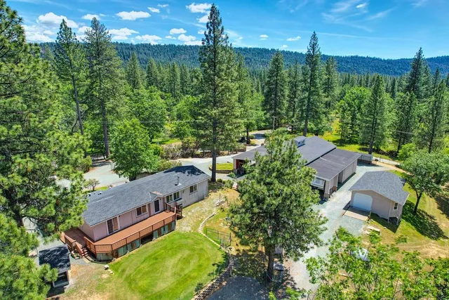 an aerial view of a house with a yard