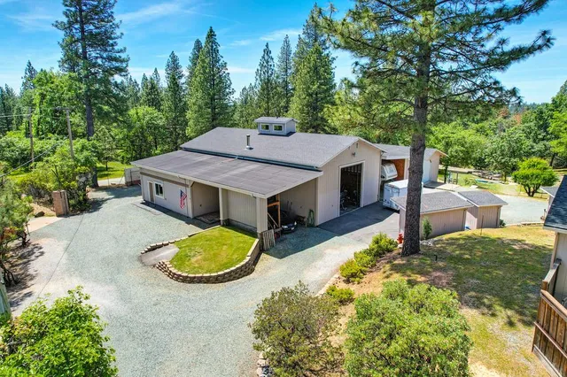 a view of a house with swimming pool and sitting area
