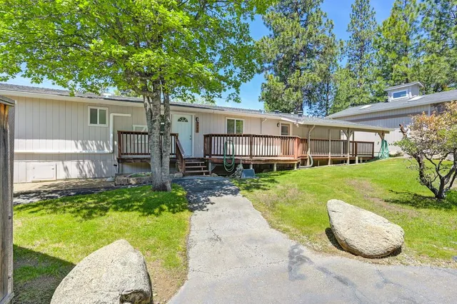 a view of a house with a yard and wooden fence