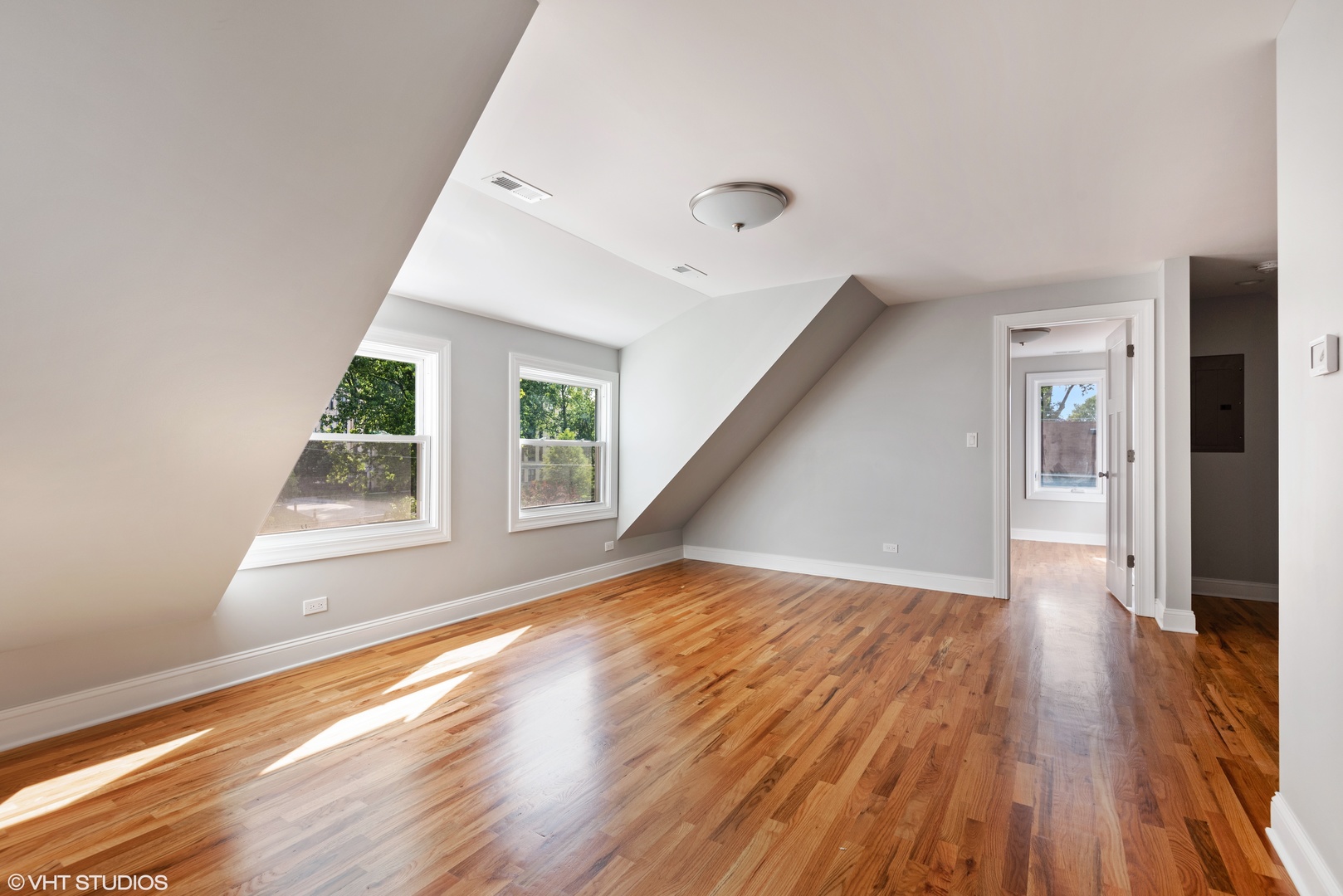 1131 Ridge Road, Unit 2 Wilmette, IL 60091 - Photo 3 of 12 an empty room with wooden floor and windows