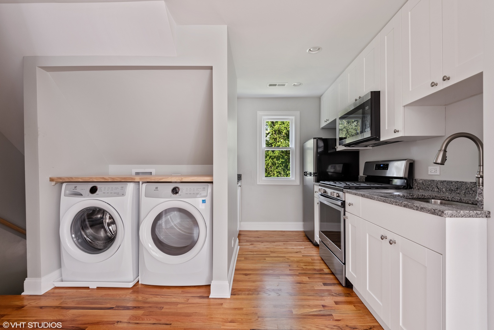 1131 Ridge Road, Unit 2 Wilmette, IL 60091 - Photo 5 of 12 a kitchen with a stove top oven sink and cabinets