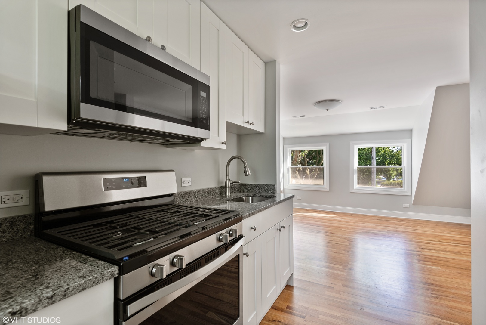 1131 Ridge Road, Unit 2 Wilmette, IL 60091 - Photo 7 of 12 a kitchen with a stove and a microwave