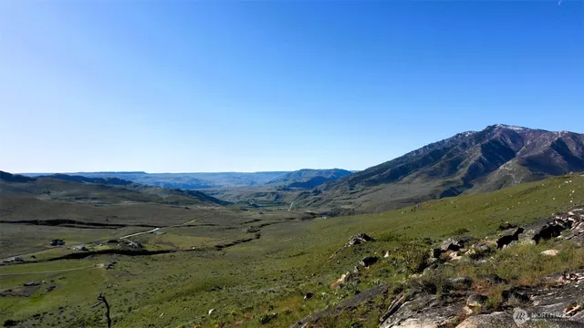 a view of a mountain with a lake in the background