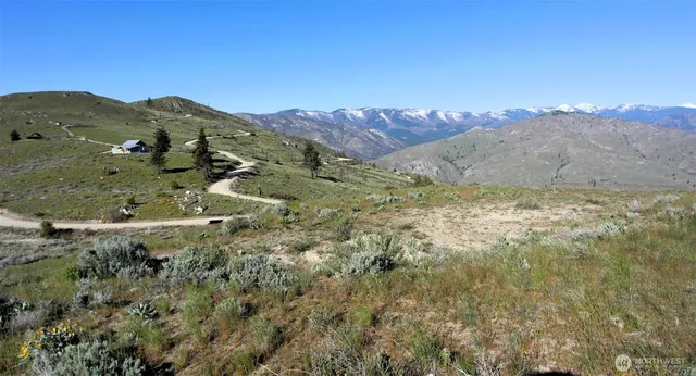 a view of mountain with sunset in background