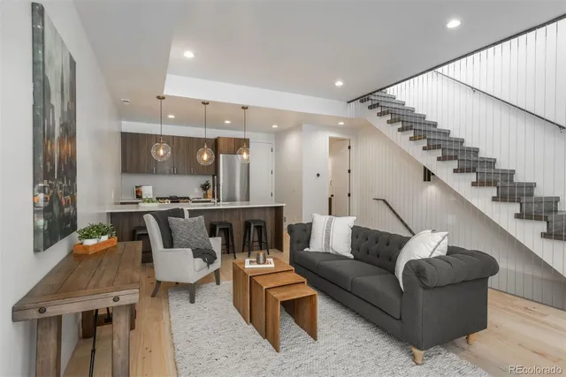 a living room with furniture and kitchen view