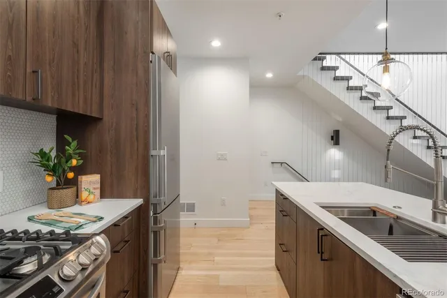 a kitchen with a sink and wooden cabinets