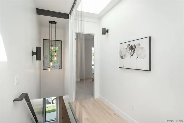 a view of a hallway with paintings on the wall