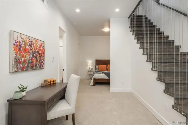 a view of a hallway with a table and chairs