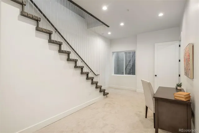 a bedroom with a bed and a lamp with wall