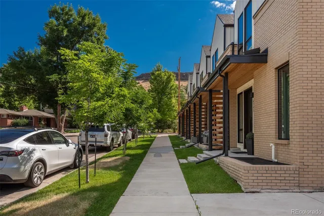 a view of a street with cars on road