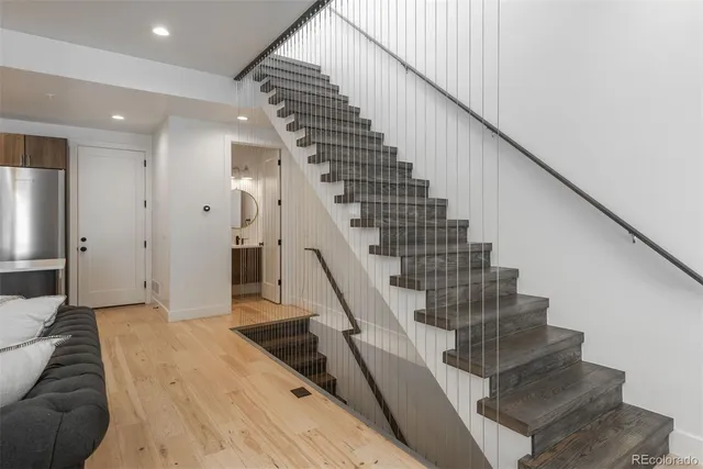 a view of entryway and hall with wooden floor