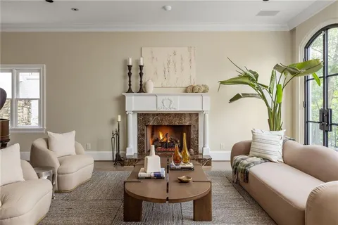 a living room with furniture a fireplace and a table