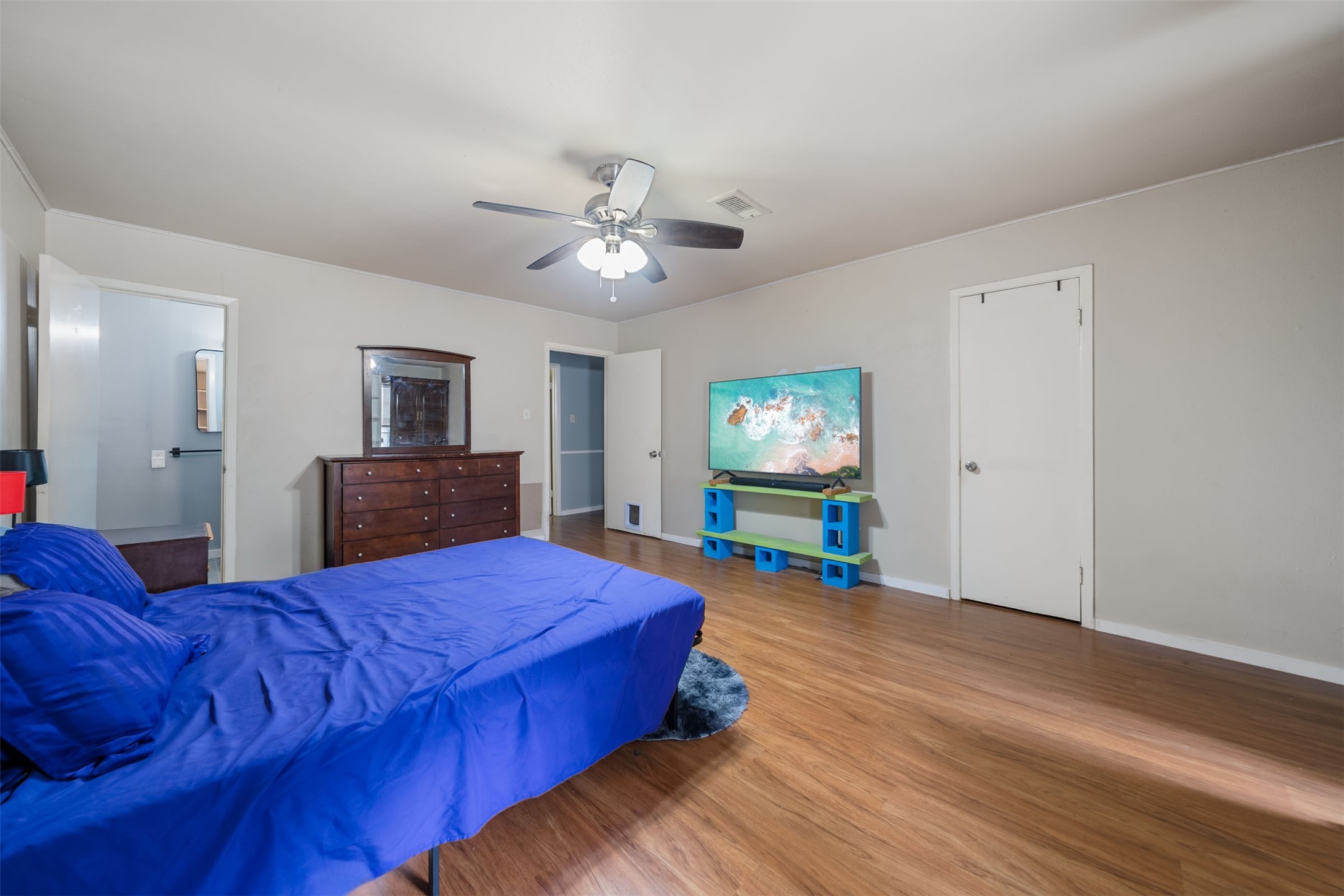 8216 Fondren Road, Unit 8216 Houston, TX 77074 - Photo 14 of 33 a bedroom with a bed and a flat tv screen on dresser