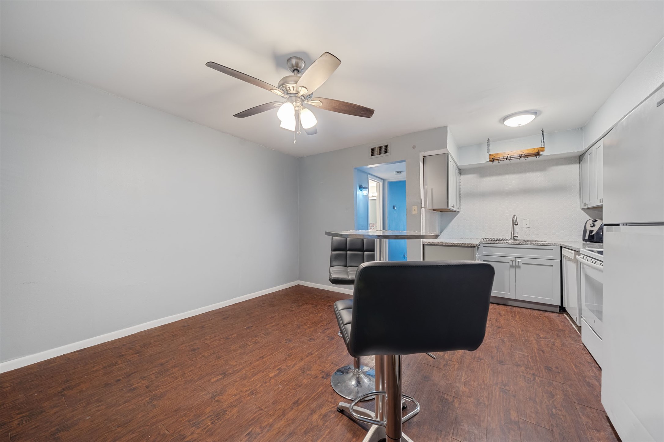 8216 Fondren Road, Unit 8216 Houston, TX 77074 - Photo 3 of 33 a view of kitchen with cabinets and wooden floor