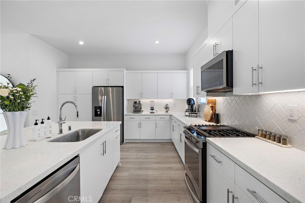 1826 West Bushell Street Anaheim, CA 92805 - Photo 13 of 30 a kitchen that has a sink and a stove top oven