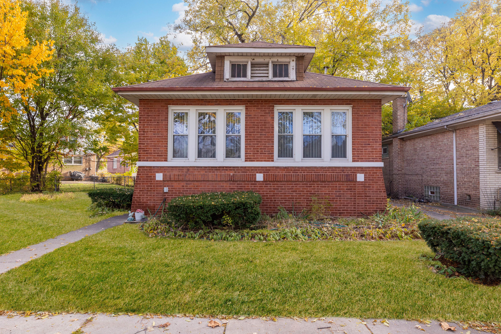 8129 South Cornell Avenue Chicago, IL 60617 - Photo 1 of 16 front view of house with a yard