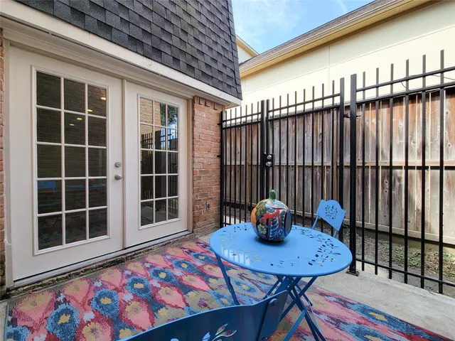 a balcony with table and chairs