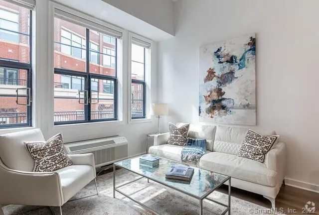 a living room with furniture and a large window