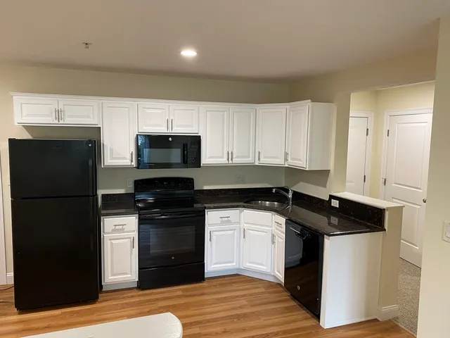 a kitchen with a refrigerator stove and microwave
