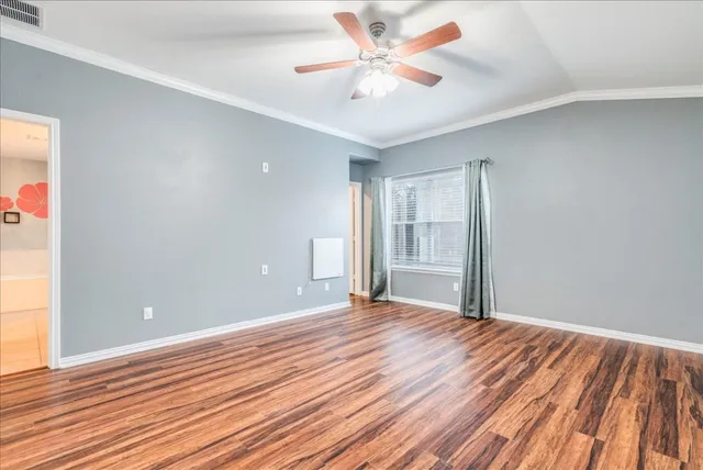 a view of an empty room and wooden floor