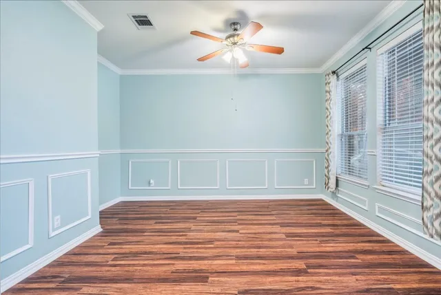 a view of a livingroom with wooden floor and stairs