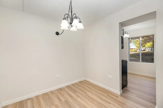 a view of a room with wooden floor and a window