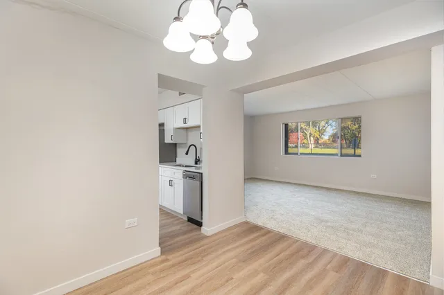 a view of a kitchen with a sink a dishwasher cabinets and wooden floor