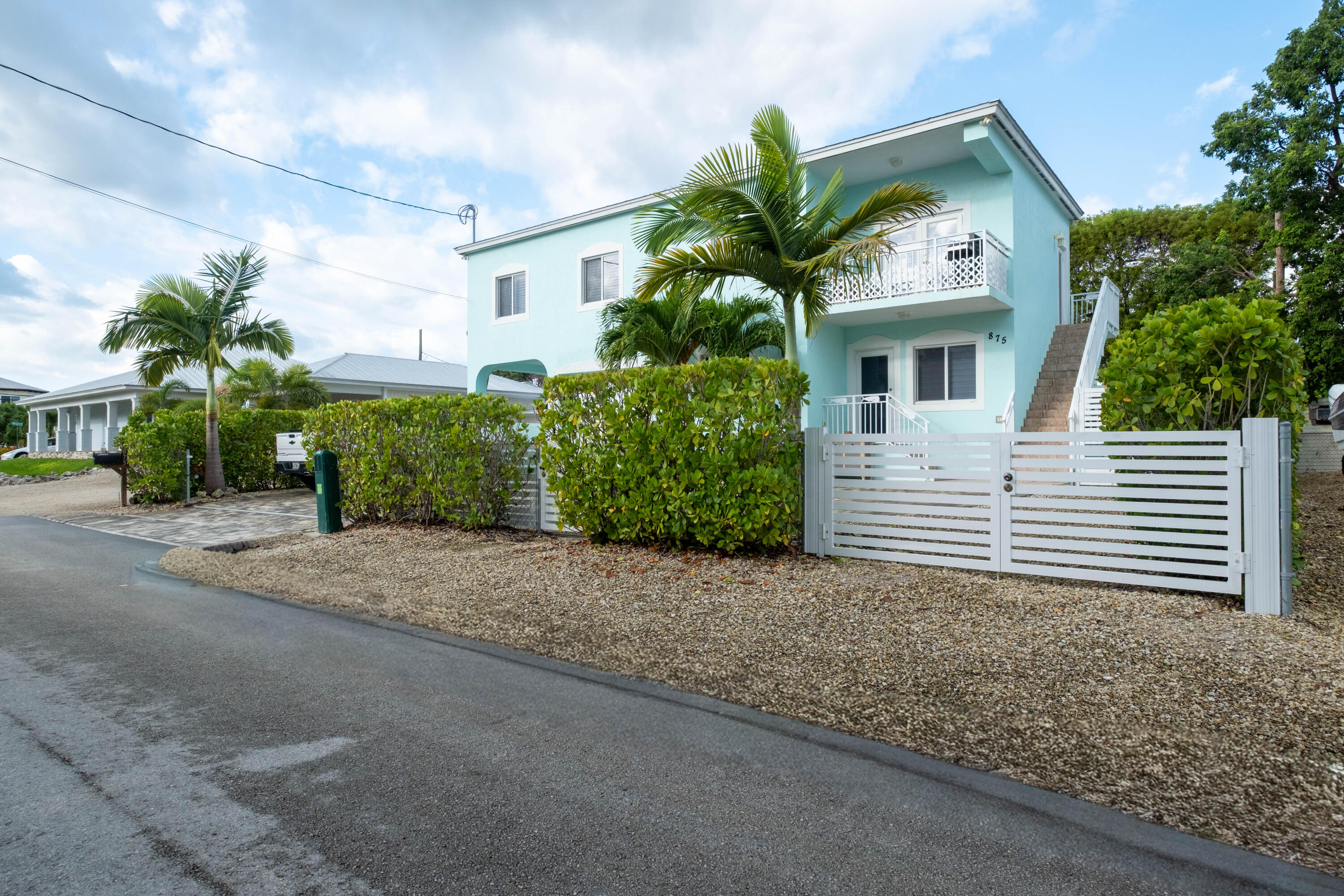 a view of a house with a small yard and plants