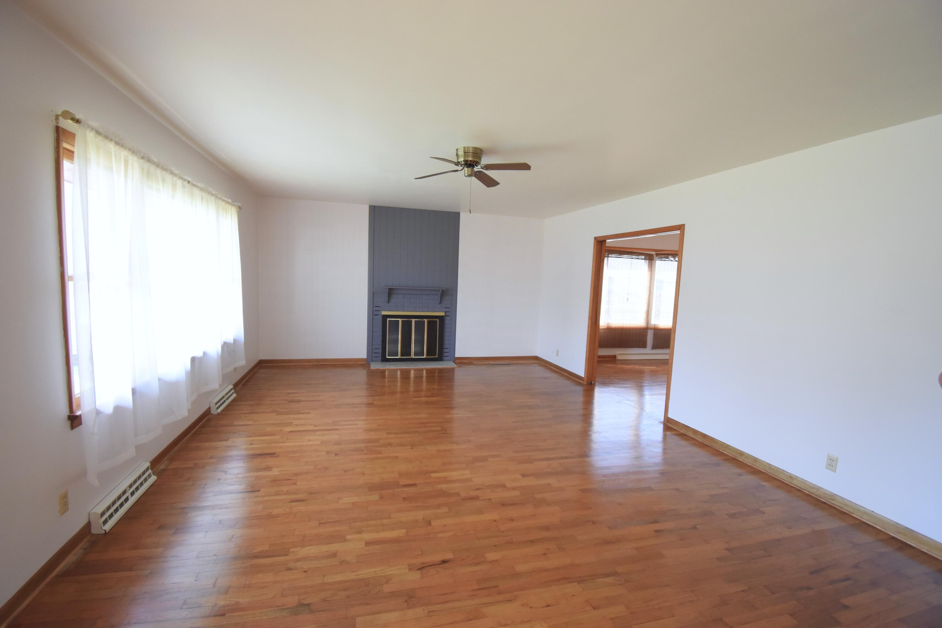 328 South Weston Street Rensselaer, IN 47978 - Photo 7 of 39 wooden floor in an empty room with a window