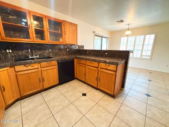 a kitchen with stainless steel appliances granite countertop a stove sink and cabinets