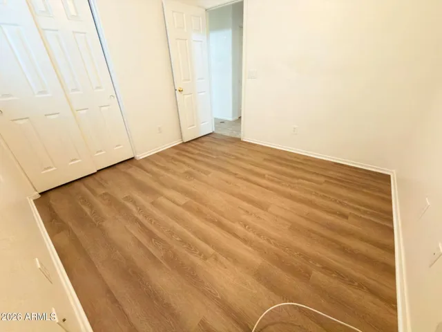 a view of a room with wooden floor