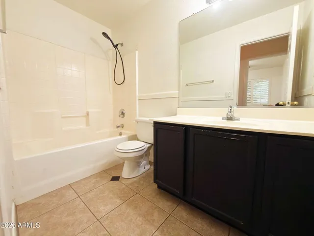 a bathroom with a double vanity sink toilet mirror and shower