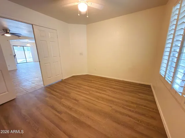 wooden floor in an empty room with a window
