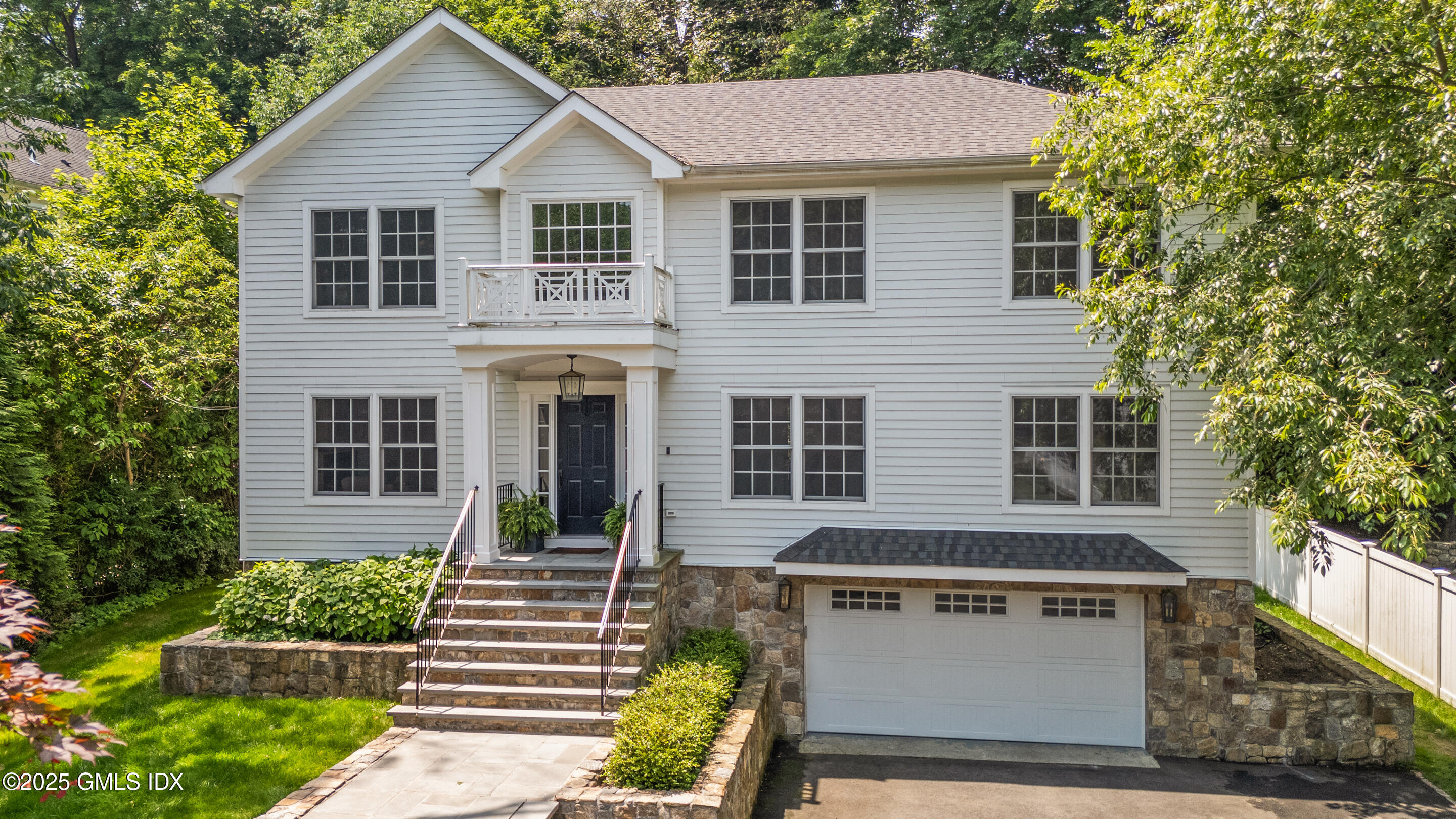108 Orchard Street Cos Cob, CT 06807 - Photo 1 of 1 a view of a white house with large windows and a small yard