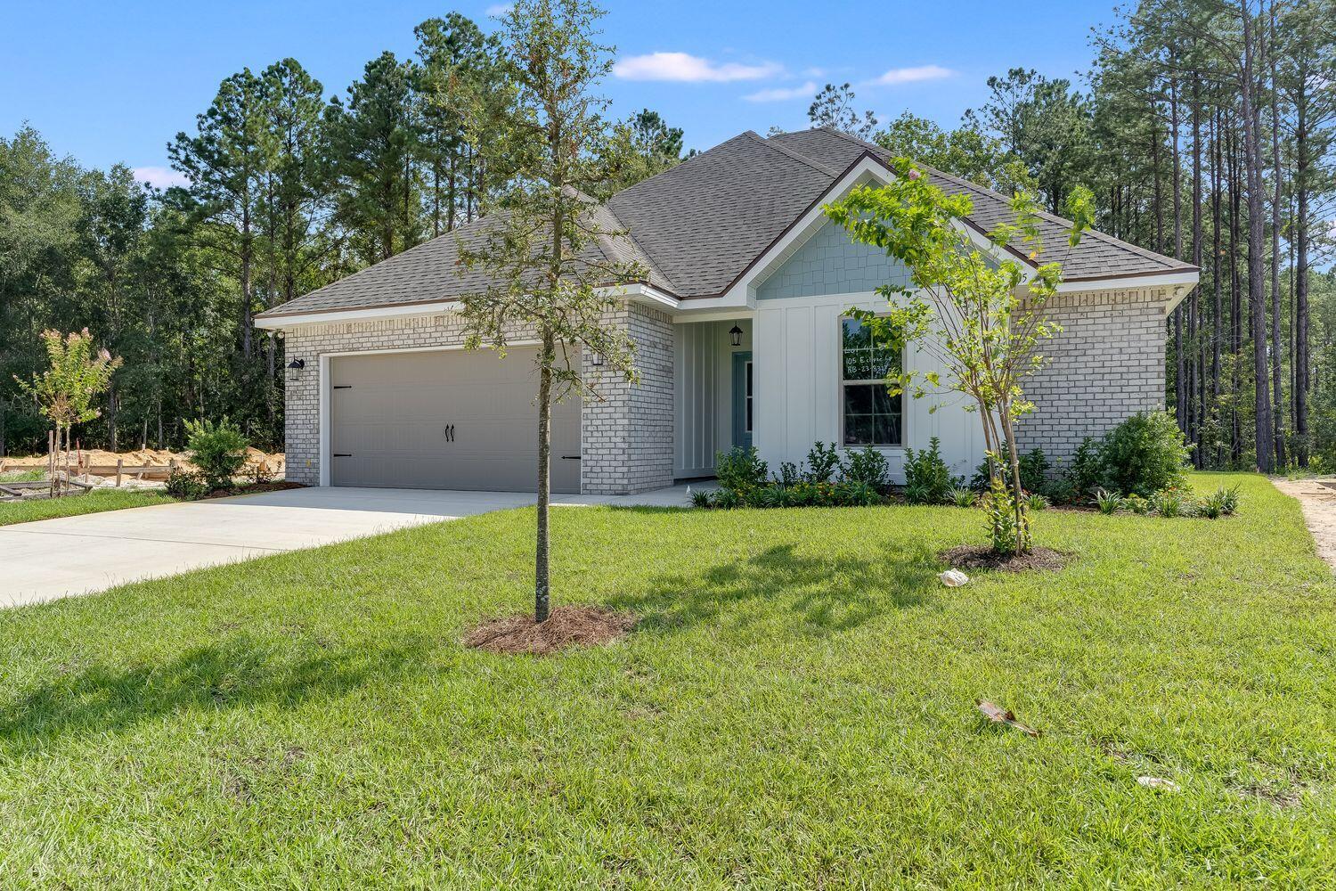 105 Eclipse Loop Freeport, FL 32439 - Photo 4 of 23 a view of a house with backyard and tree s