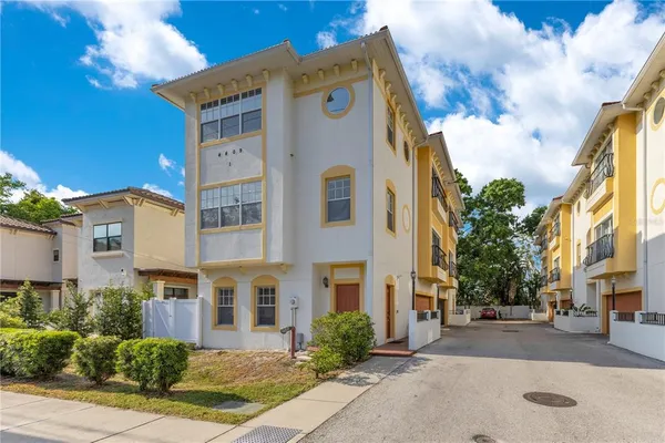 a front view of a residential apartment building with a yard