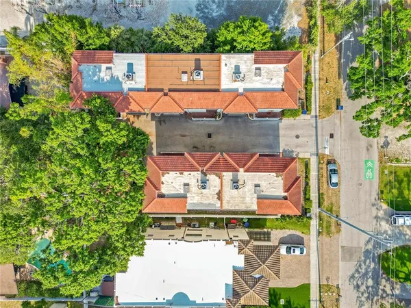 an aerial view of residential houses with yard