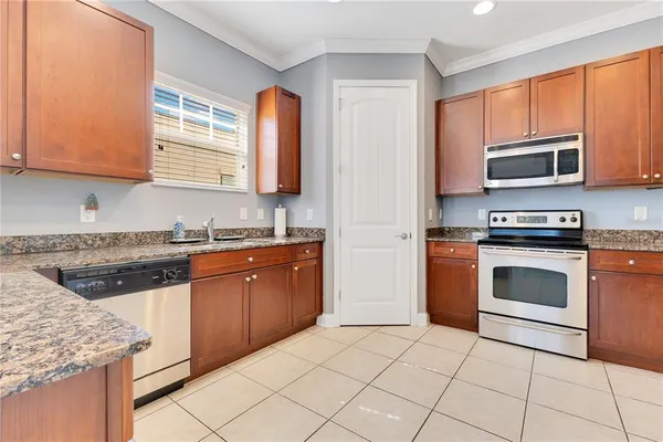 a kitchen with stainless steel appliances granite countertop a stove microwave and sink
