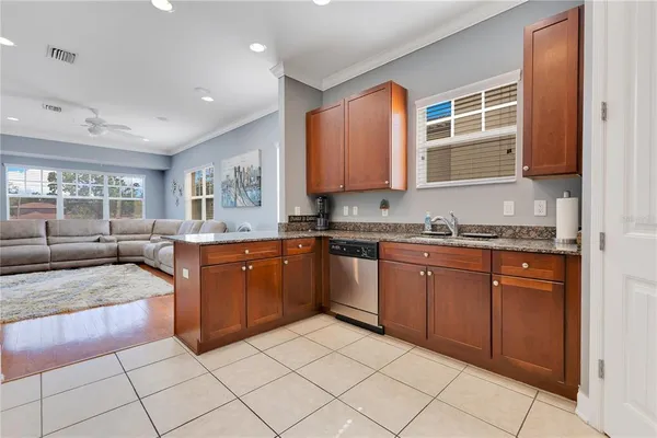 a kitchen with granite countertop a sink and cabinets