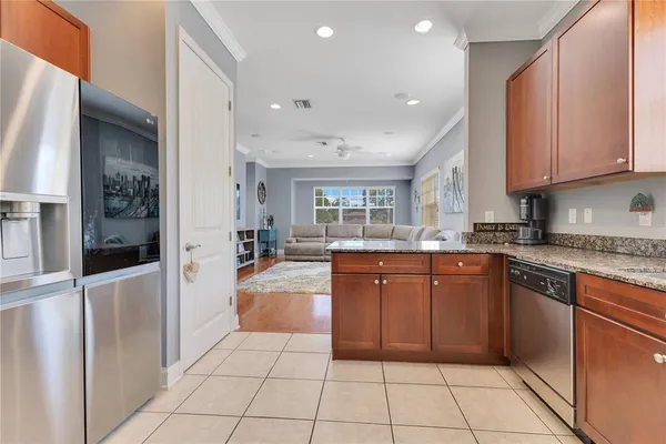 a large kitchen with stainless steel appliances granite countertop a refrigerator and a sink